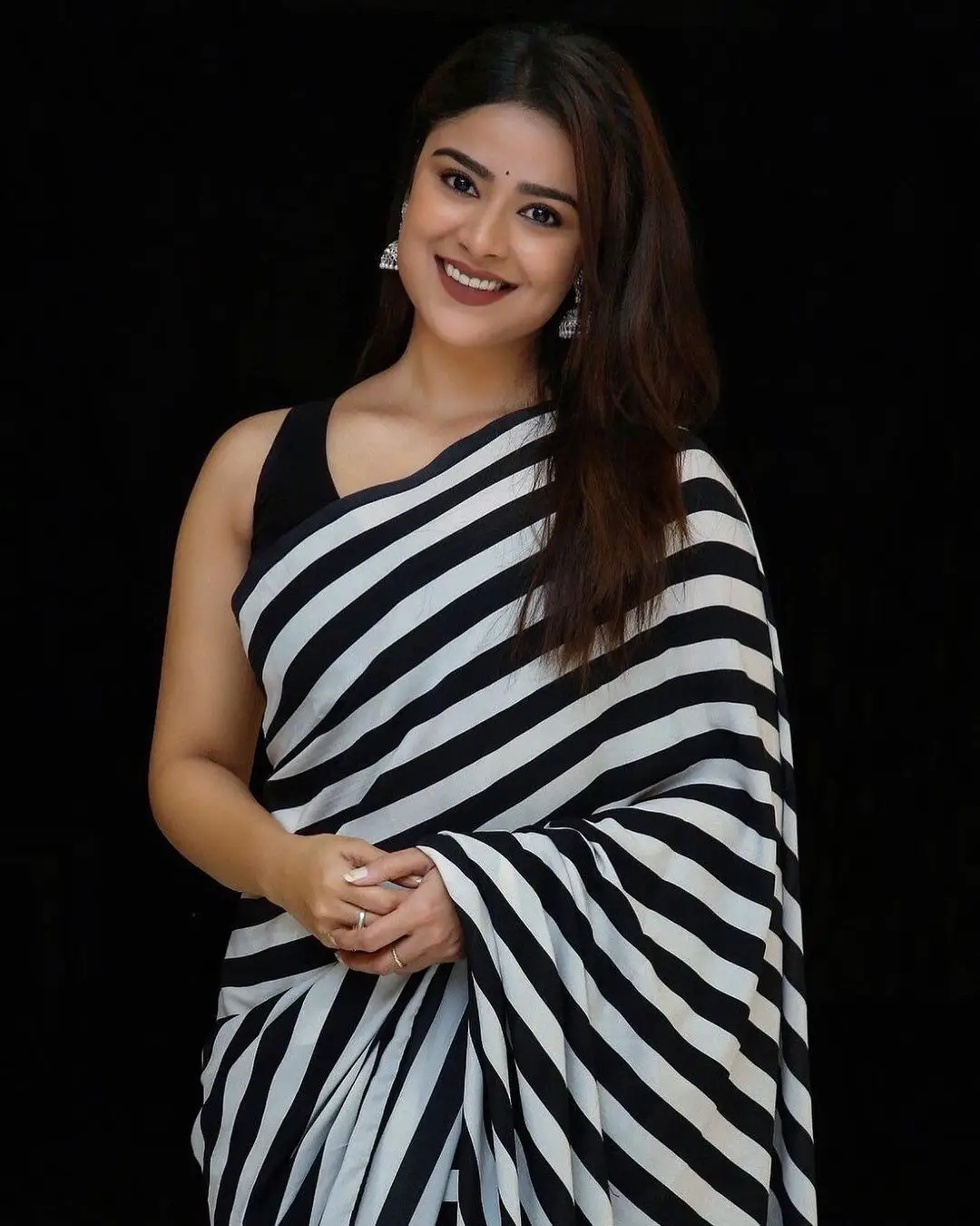 Priyanka Sharma Stills In Black Saree Sleeveless Blouse